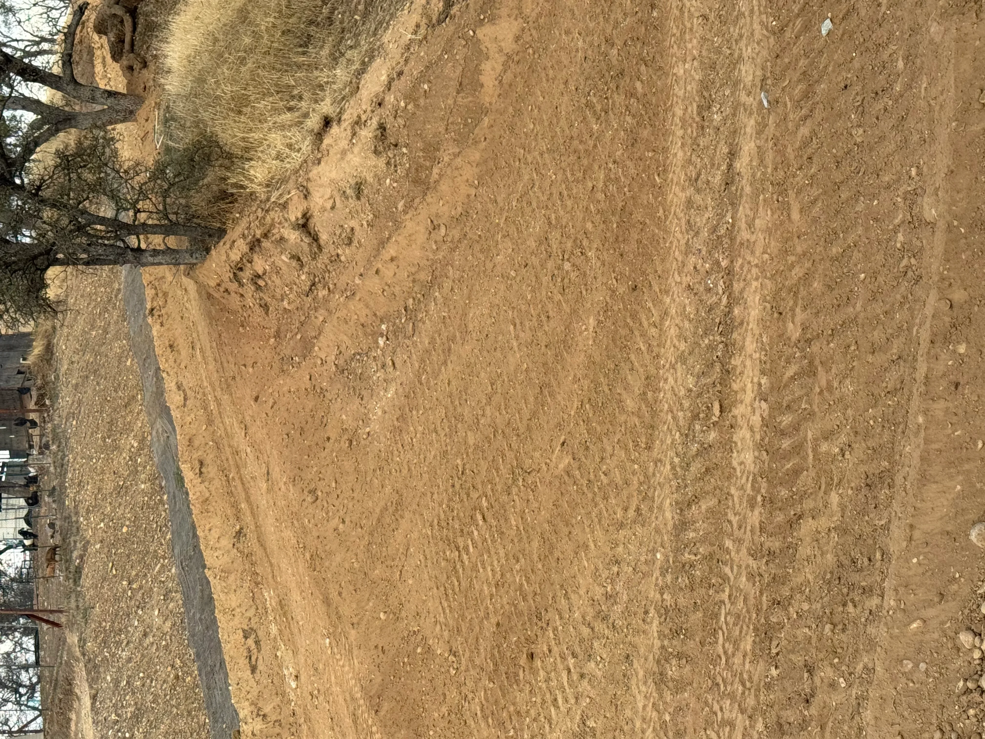 Compacted dirt subgrade prepared for asphalt paving installation