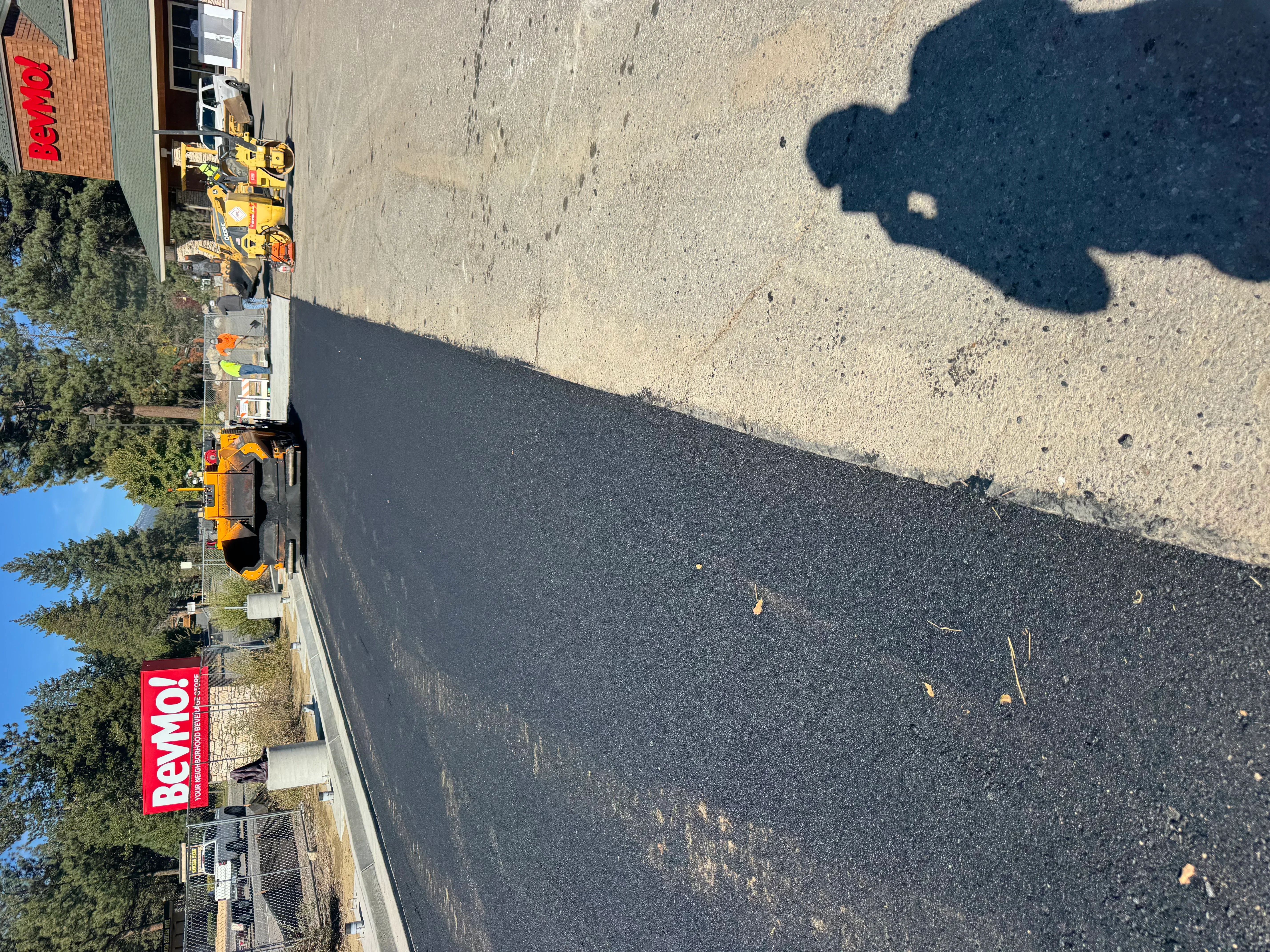 Newly paved commercial asphalt lot with dark surface and proper grading