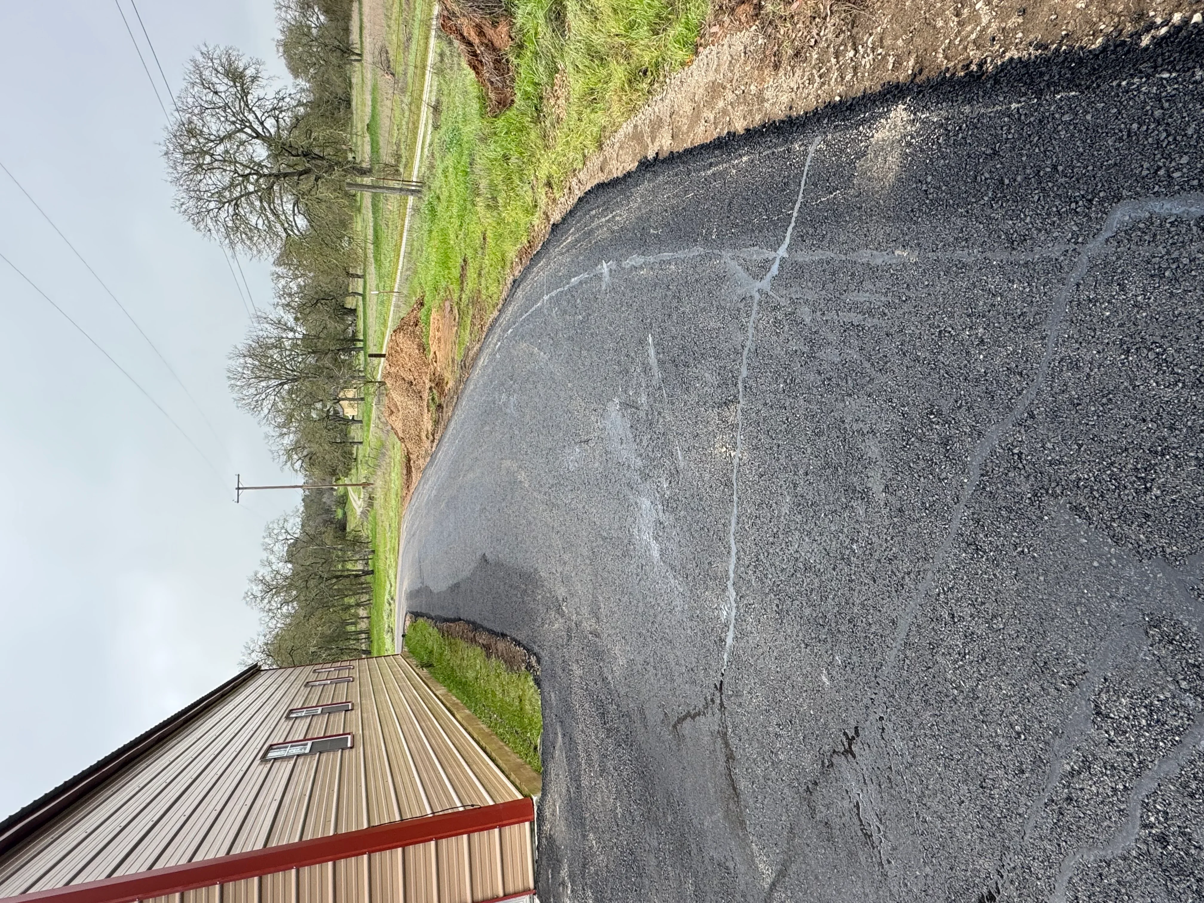 Newly paved asphalt driveway with clean edges and proper grading in Valley Springs